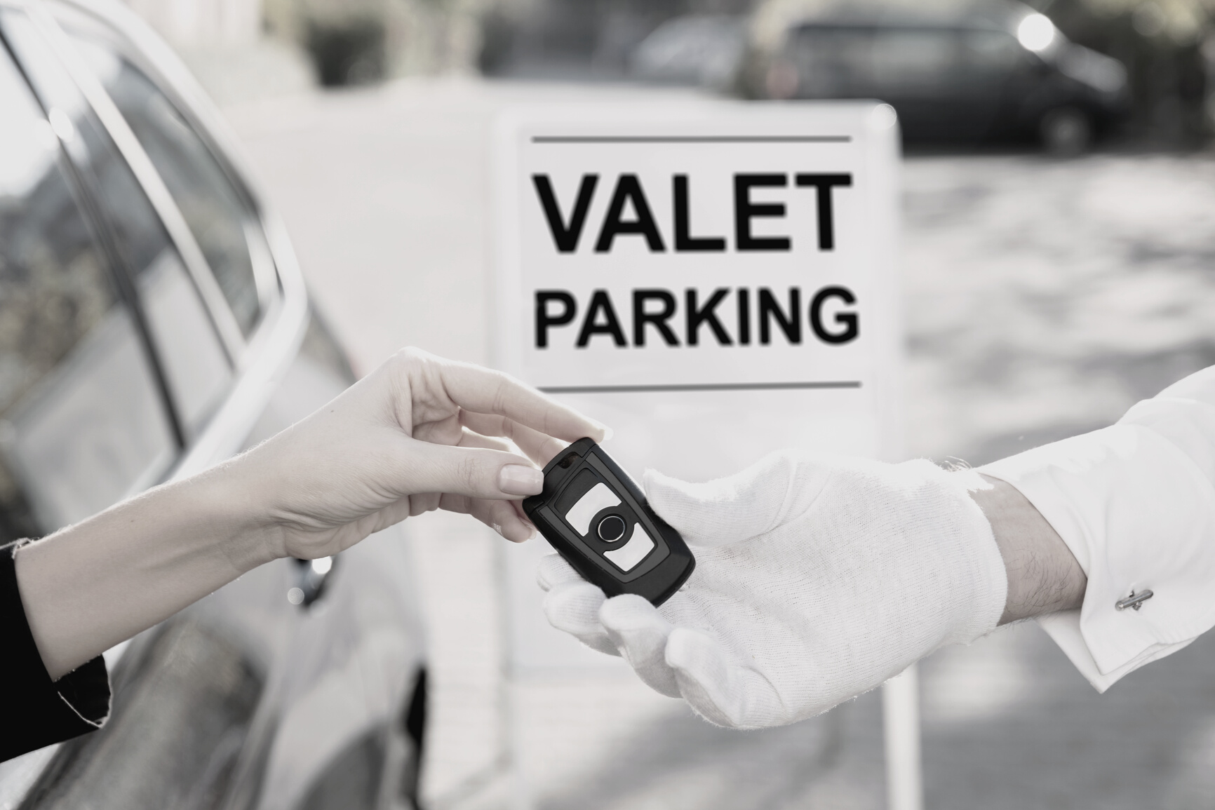 Woman Giving Car Key To Male Valet